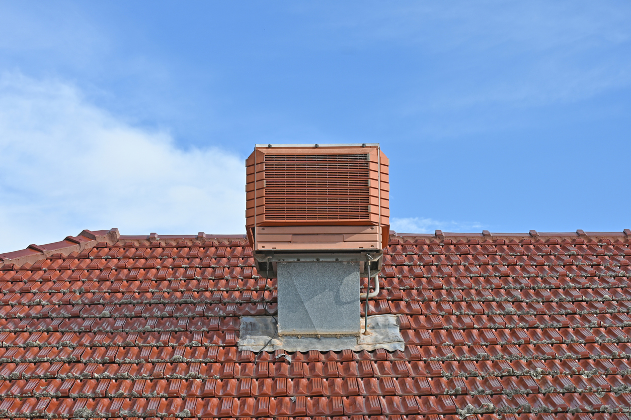 Outdoor evaporative cooler unit on the side of a Redding home during wildfire smoke season.